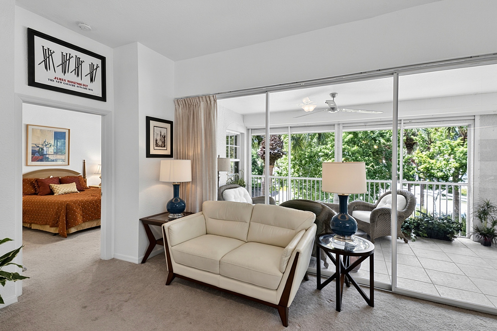 Living room open to lanai with tropical views
